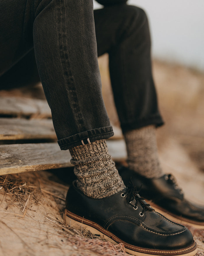 fit model showing off the cuffs on The Slim Jean in Washed Black Organic Slub Selvedge