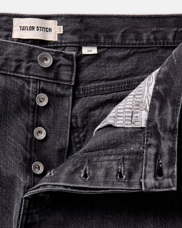 material shot of the button fly on The Slim Jean in Washed Black Organic Slub Selvedge