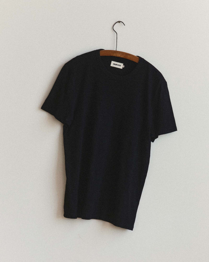 fit model showing off the pocket on The Organic Cotton Tee in Black Indigo