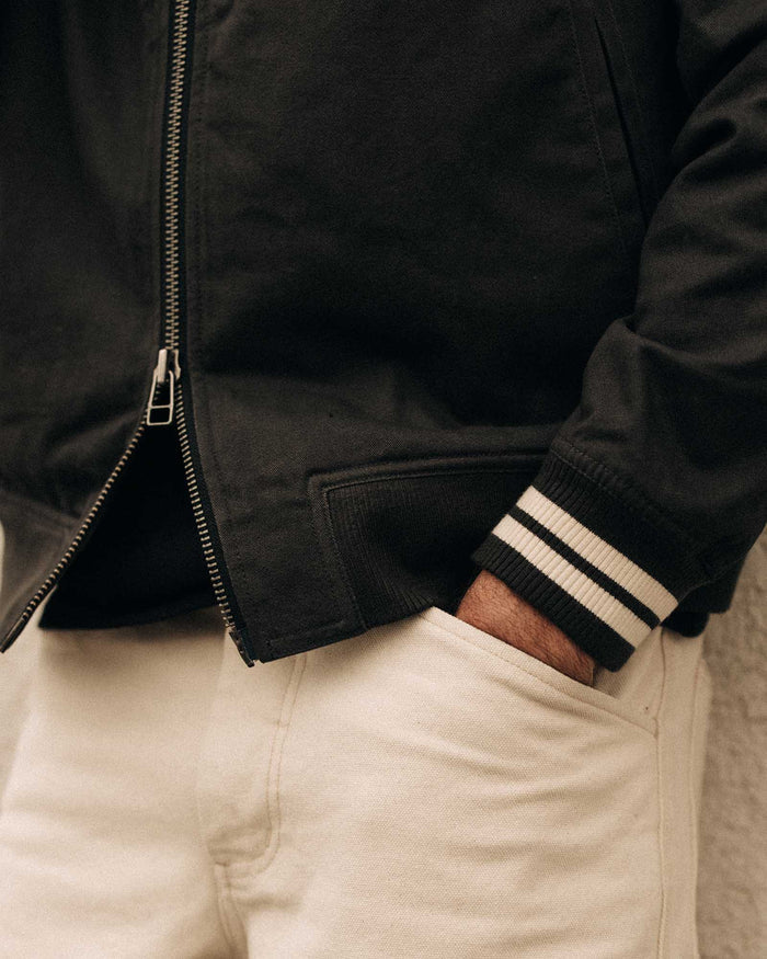 fit model with his hand in the pocket of The Speedway Bomber in Organic Faded Black Twill