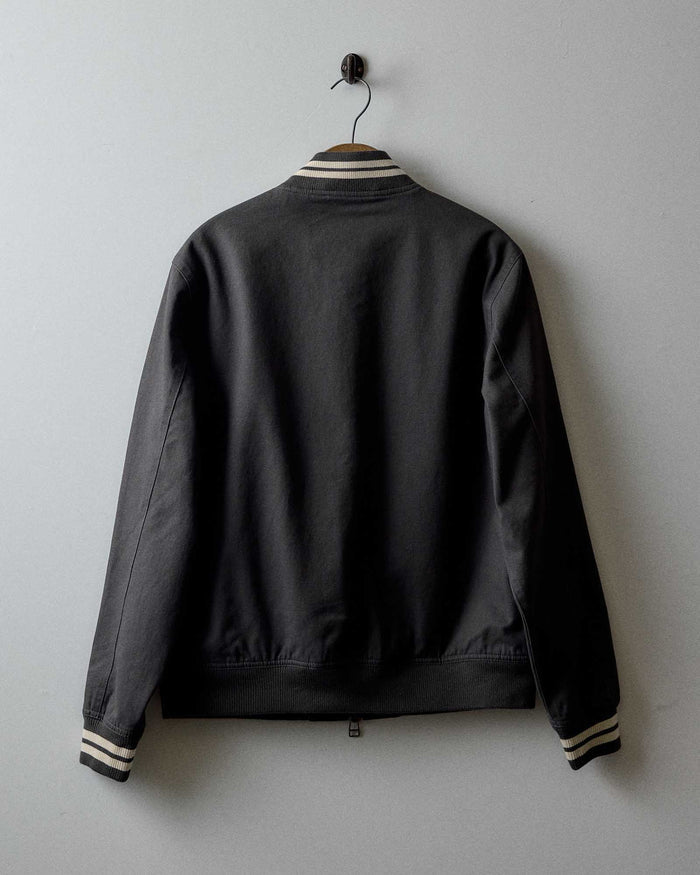 editorial image of the back of The Speedway Bomber in Organic Faded Black Twill hanging