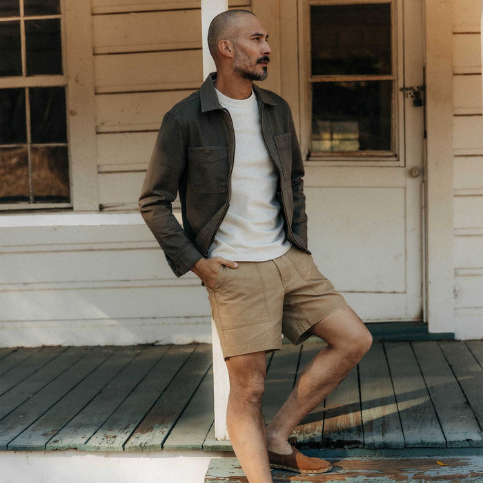fit model on the stairs wearing The Station Jacket in Fatigue Olive Broken Twill