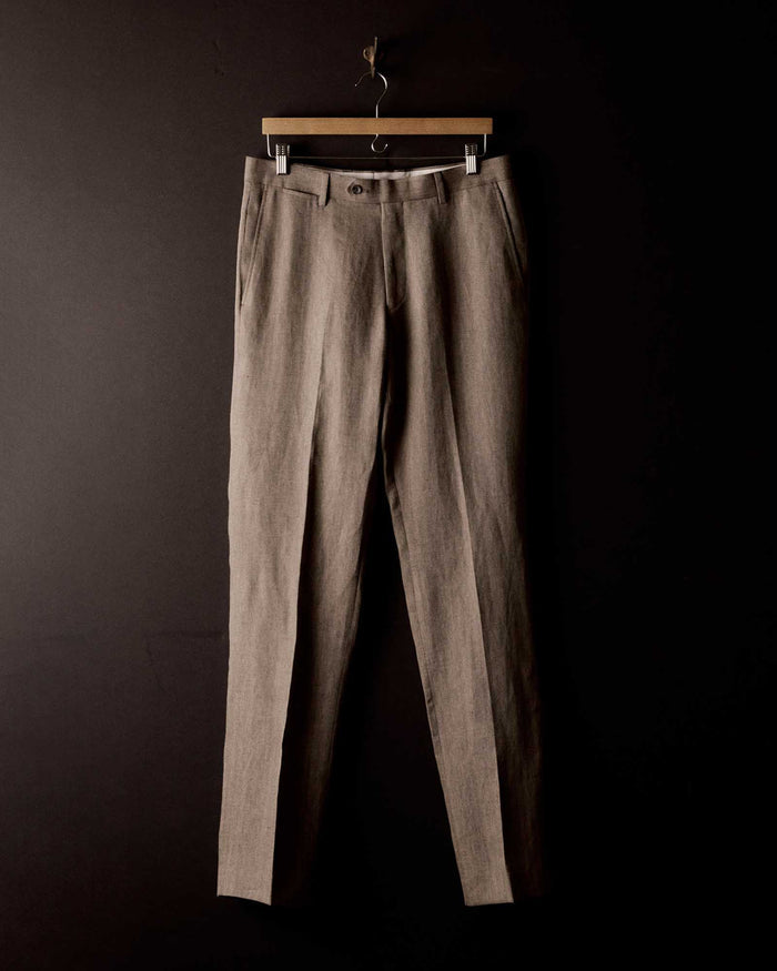editorial image of The Stevens Trouser in Coffee Linen Herringbone hanging