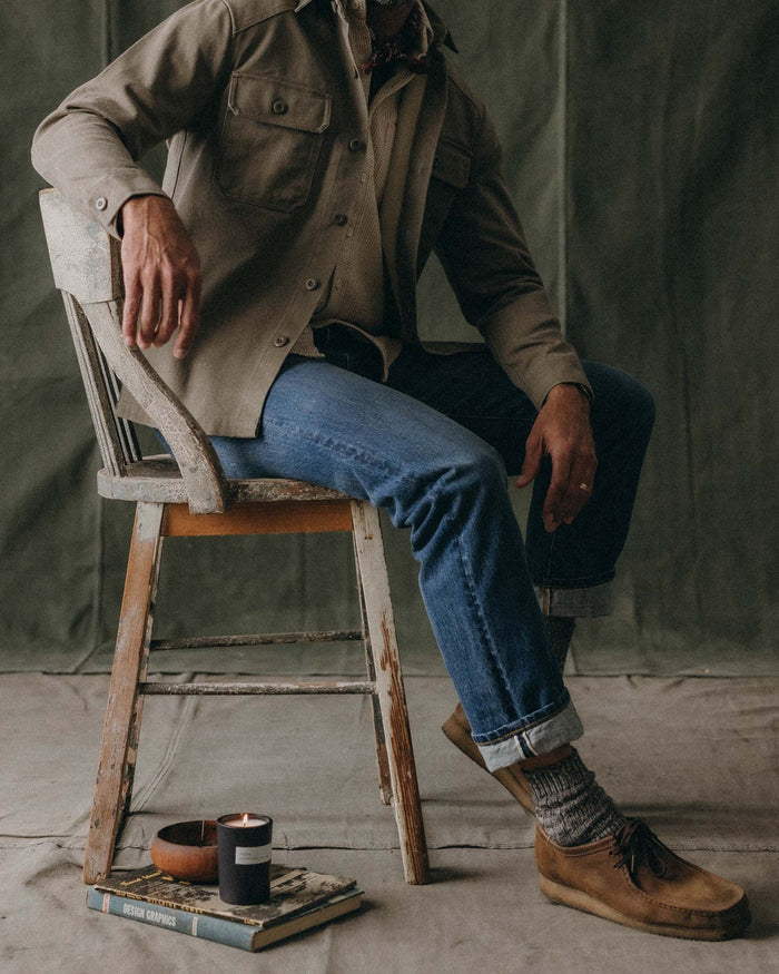 fit model sitting in The Straight Jean in Mid Wash Organic Selvedge