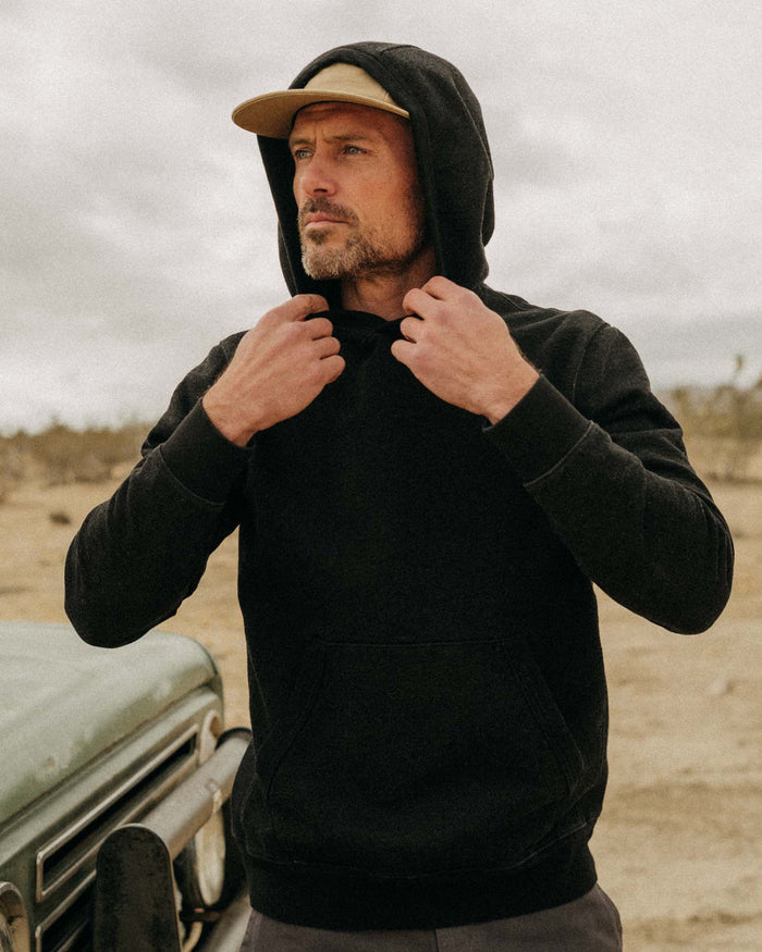 fit model showing off the hood of The Apres Hoodie in Black Indigo Terry