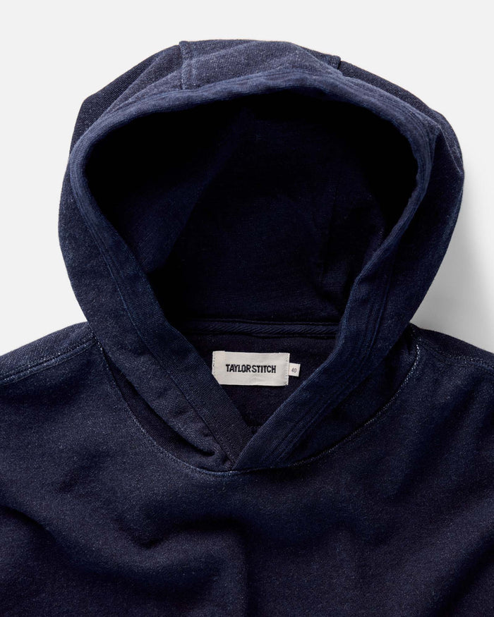 fit model with his hands in the kangaroo pocket of The Apres Hoodie in Indigo Terry