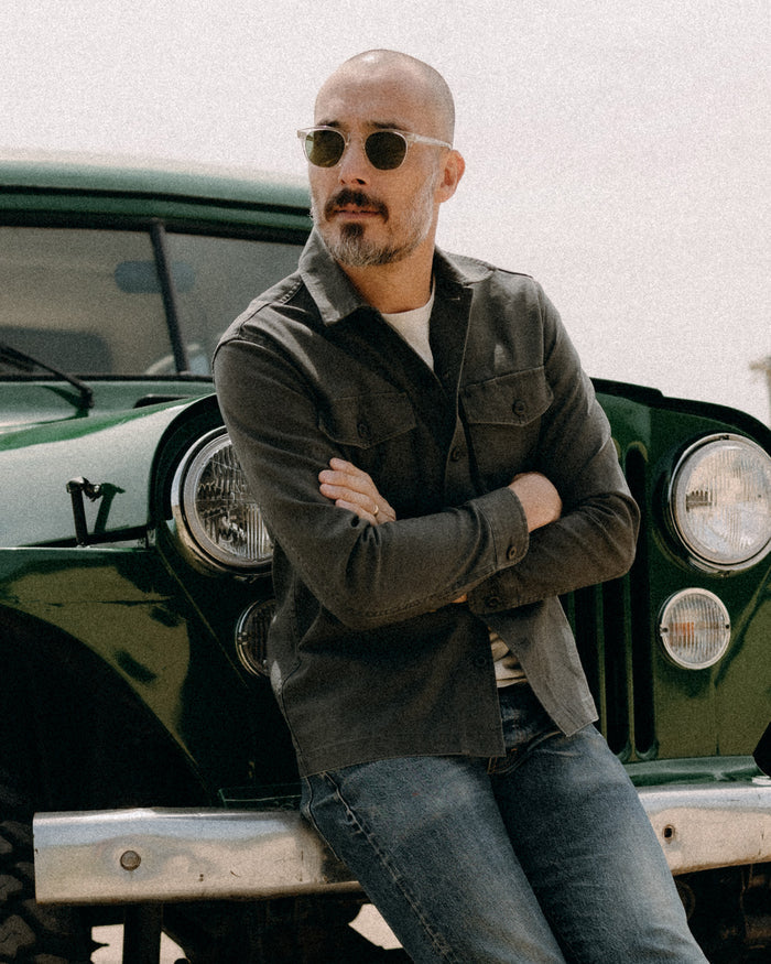 fit model sitting wearing The Surplus Shirt in Faded Black Reverse Sateen
