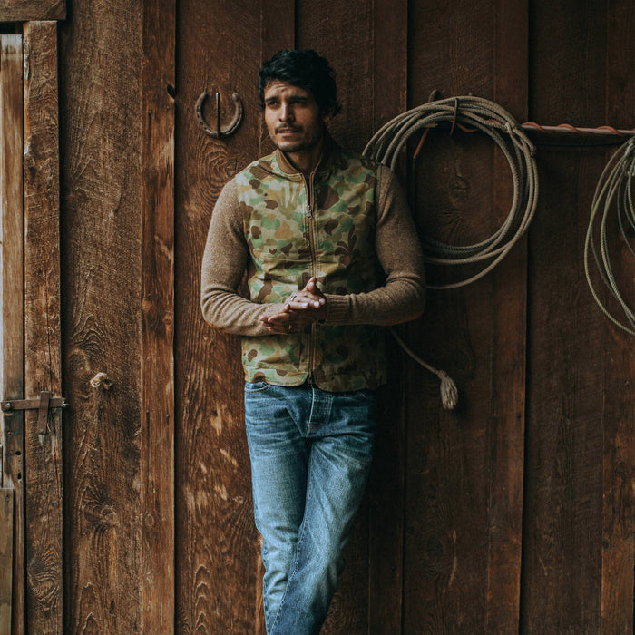 our fit model wearing The Reversible Able Vest in Arid Camo—reversed camo side