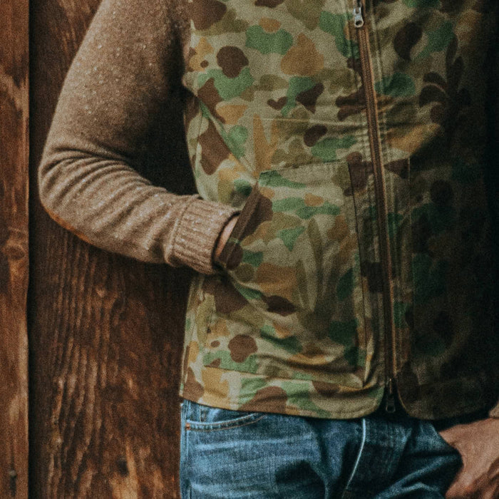 our fit model wearing The Reversible Able Vest in Arid Camo—reversed camo side close up