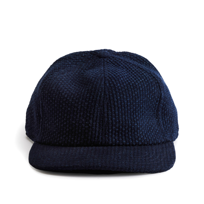 flatlay of the front of a TS x Hypeadelic cap