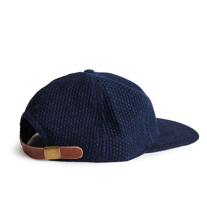 flatlay of the back of a TS x Hypeadelic cap