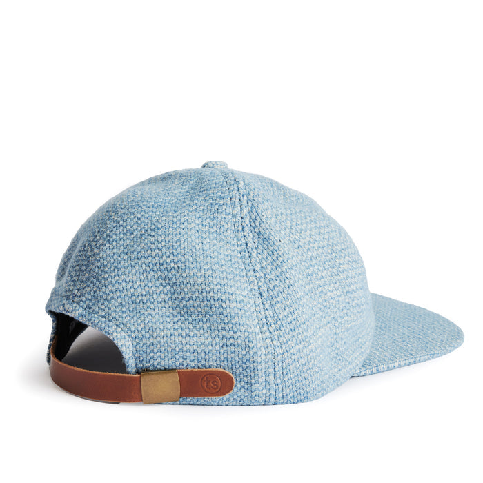 flatlay of the back of a TS x Hypeadelic cap