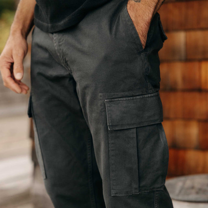 fit model with his hand in his pocket wearing The Tommie Pant in Faded Black