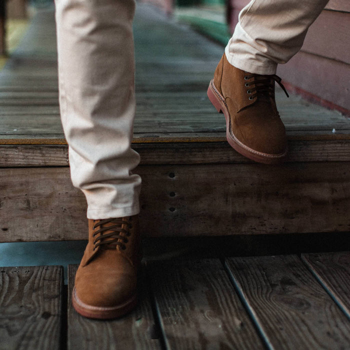 fit model wearing The Trench Boot in Butterscotch Weatherproof Suede, walking down stairs