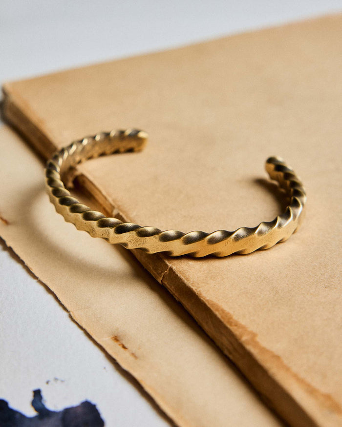 editorial image of The Twisted Cuff in Brass on a piece of paper