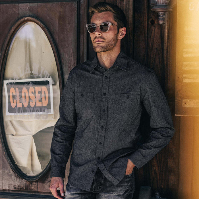 fit model leaning against the wall wearing The Utility Shirt in Ash Jaspe