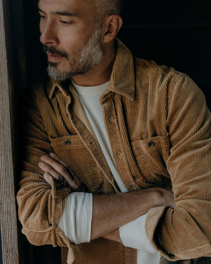 fit model leaning against the wall wearing The Utility Shirt in Bourbon Corduroy