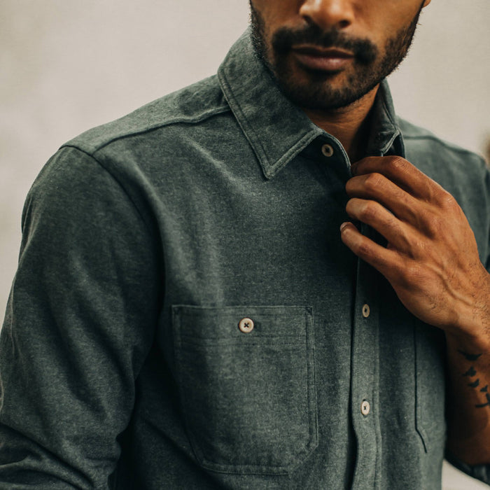 fit model adjusting collar of The Utility Shirt in Dark Slate Heavy Bag