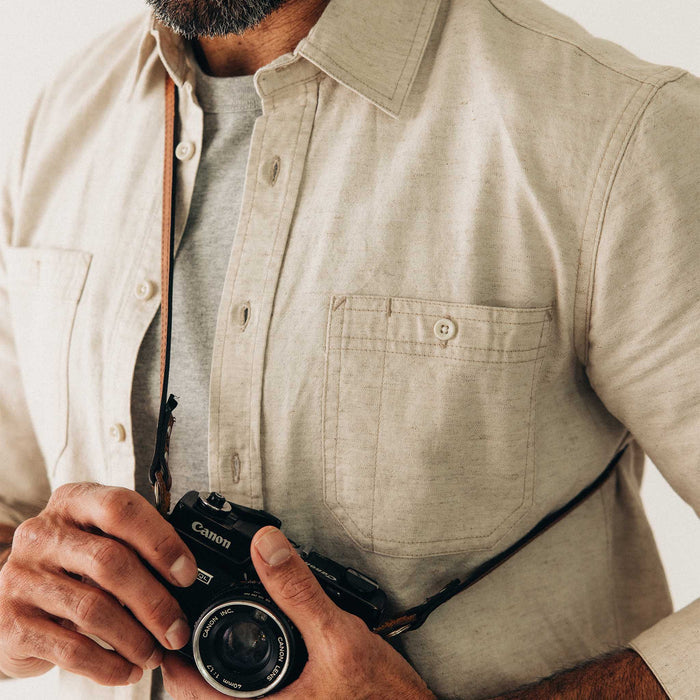fit model holding a camera wearing The Utility Shirt in Natural Nep