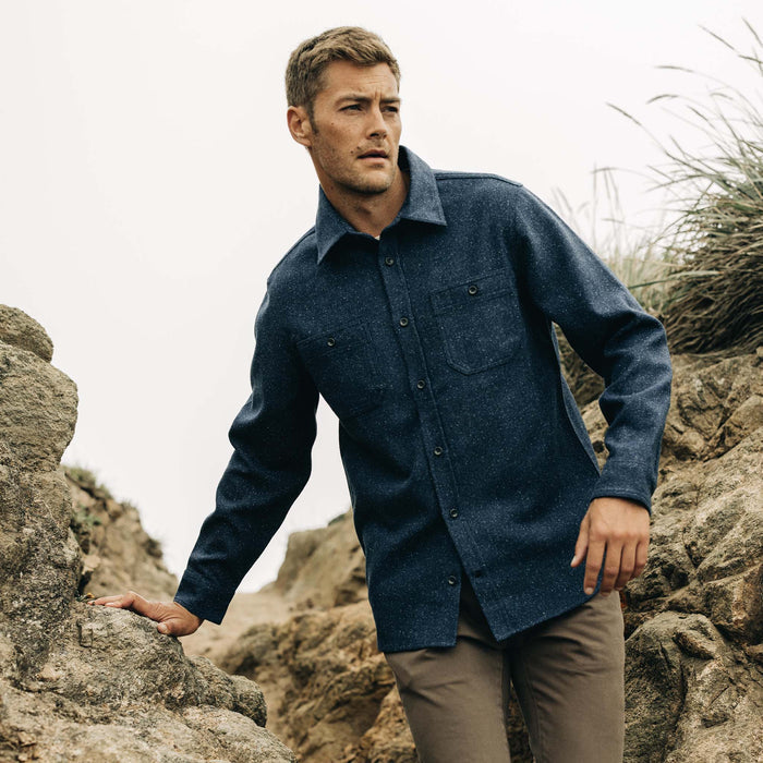 fit model on rocks wearing The Utility Shirt in Navy Donegal Wool