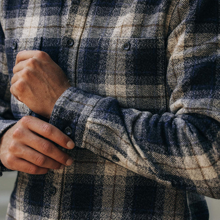 fit model adjusting cuffs on The Utility Shirt in Navy Jaspe Herringbone Plaid