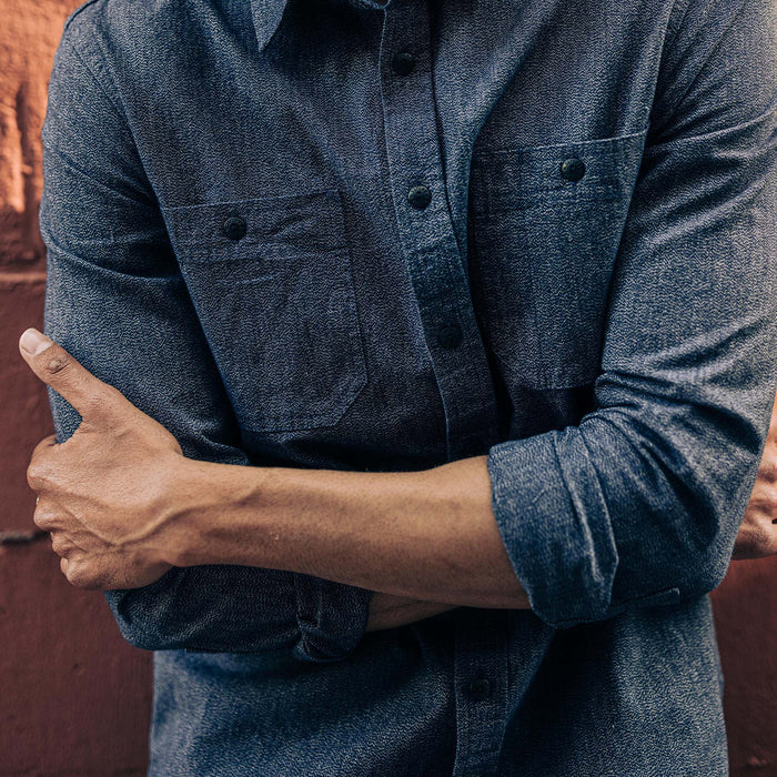 fit model with his arms crossed wearing The Utility Shirt in Navy Jaspe