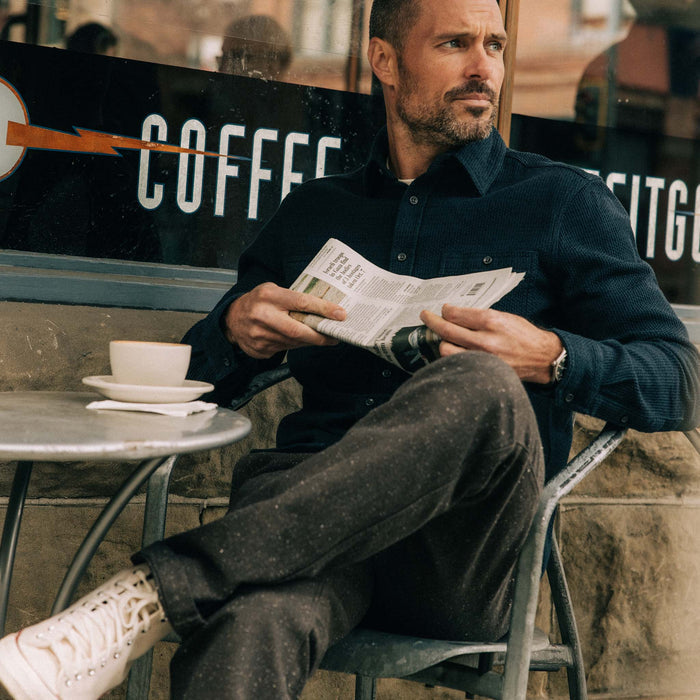 fit model sitting wearing The Utility Shirt in Navy Sashiko
