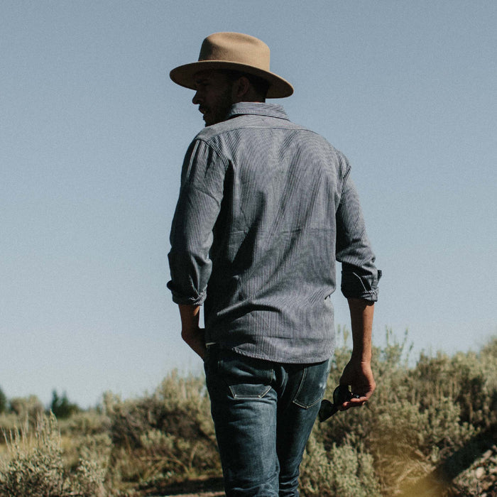 Fit model wearing The Utility Shirt in Roped Indigo in a field