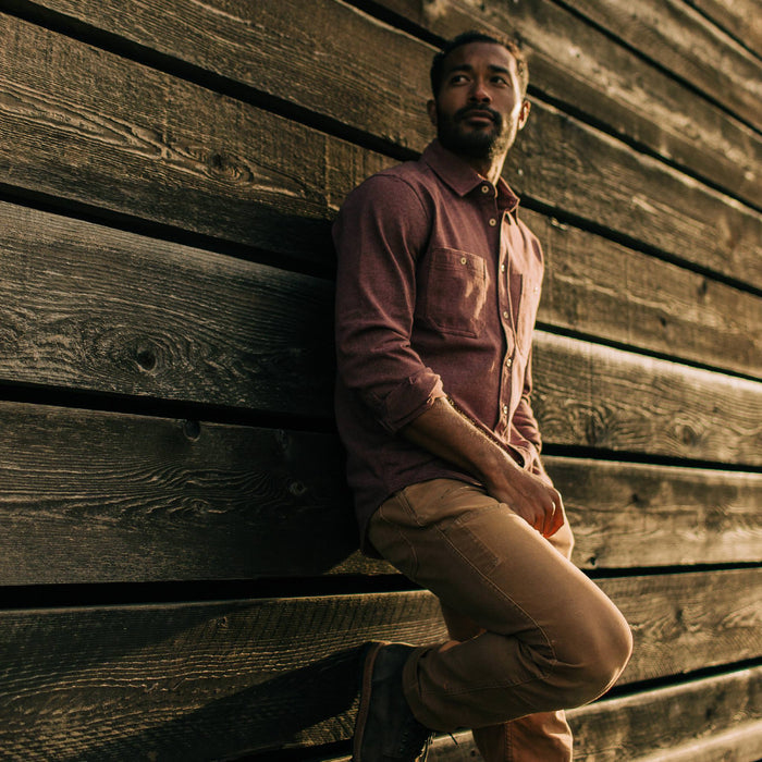 fit model leaning against wall in The Utility Shirt in Russet Heavy Bag