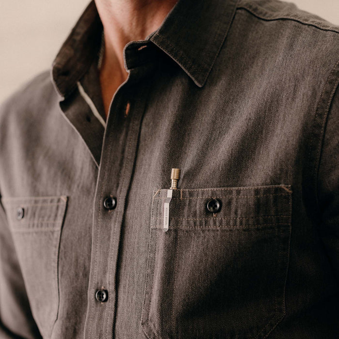 fit model showing off the pockets on The Utility Shirt in Soil Selvedge Denim