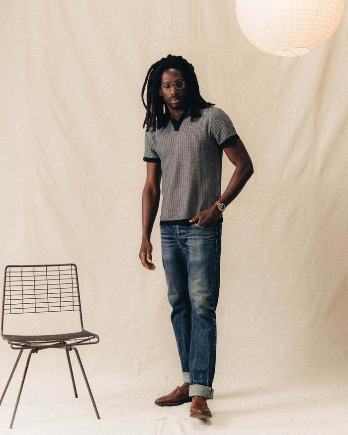 fit model posing in The Valencia Sweater Polo in Coal Scallop