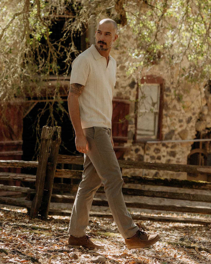 fit model walking wearing The Valencia Sweater Polo in Heather Oat Rib