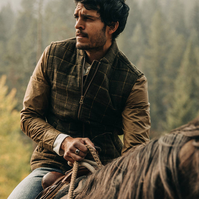 fit model wearing The Vertical Vest in Olive Plaid Wool, looking left