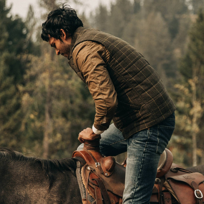 fit model wearing The Vertical Vest in Olive Plaid Wool, on horse