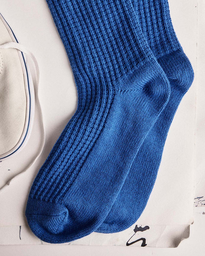 editorial flatlay of The Waffle Sock in Cobalt next to a shoe