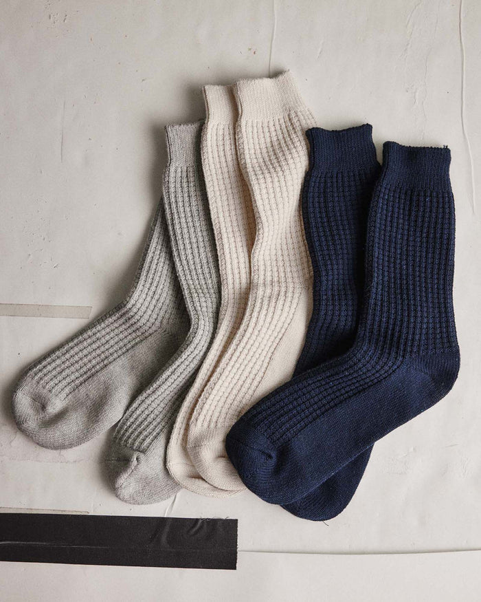 editorial flatlay of The Waffle Sock in Natural next to other socks