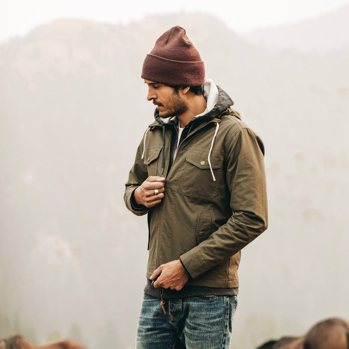 our fit model wearing The Welterweight Winslow in Olive Dry Waxed Canvas—looking left