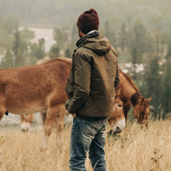 our fit model wearing The Welterweight Winslow in Olive Dry Waxed Canvas—looking out to valley