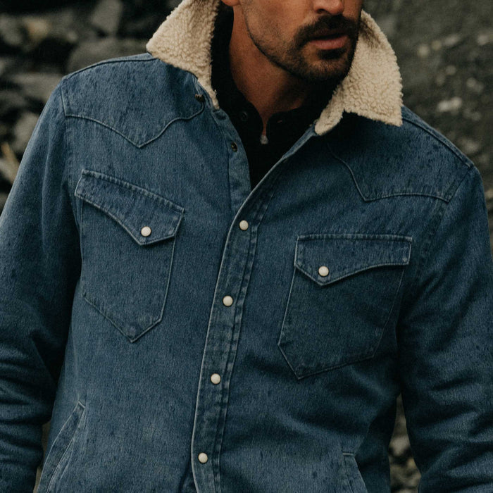 fit model adjusting buttons on The Western Shirt Jacket in Washed Indigo