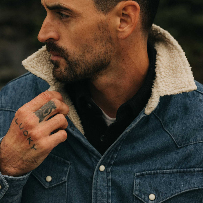 fit model with his hand in his pocket wearing The Western Shirt Jacket in Washed Indigo