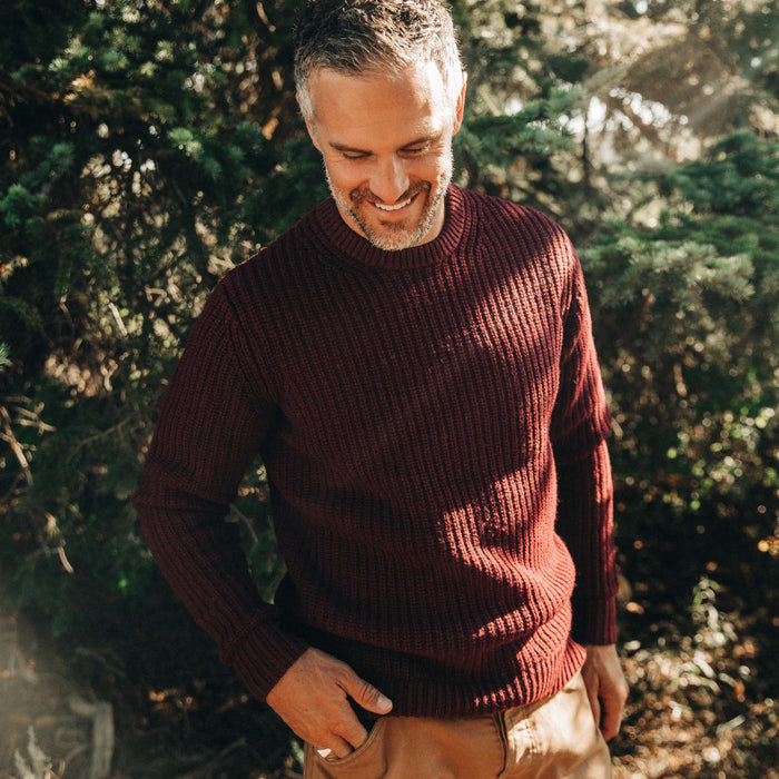 fit model wearing The Wharf Sweater in Burgundy looking down