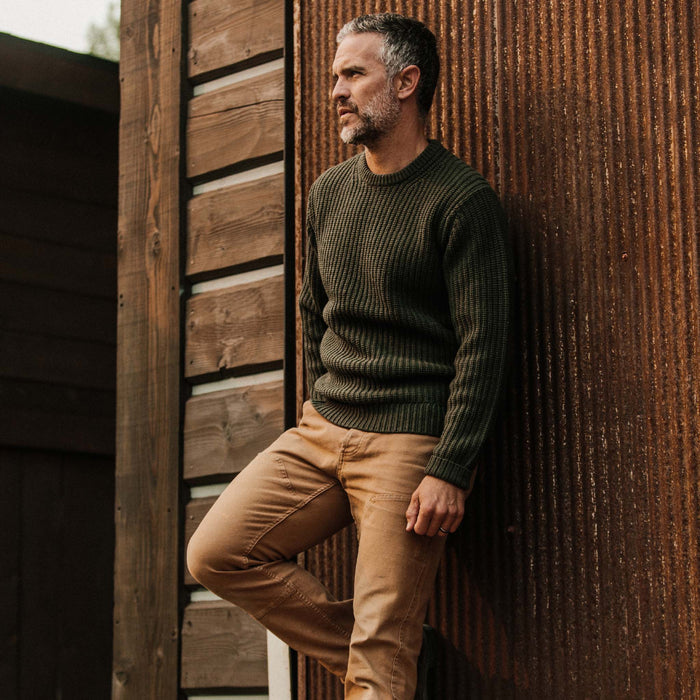 fit model wearing The Wharf Sweater in Dark Olive looking out