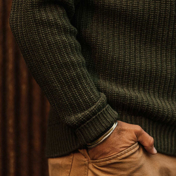 fit model wearing The Wharf Sweater in Dark Olive with hand in pocket