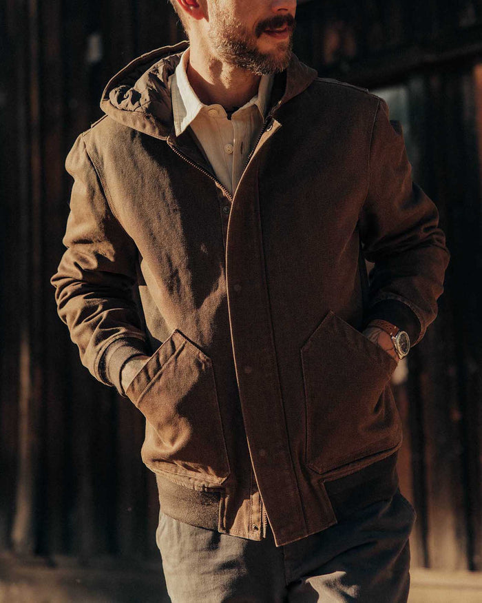 fit model with his hands in his pockets wearing The Workhorse Hoodie in Aged Penny Chipped Canvas
