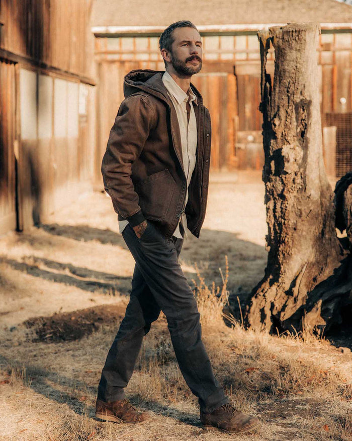 fit model walking wearing The Workhorse Hoodie in Aged Penny Chipped Canvas