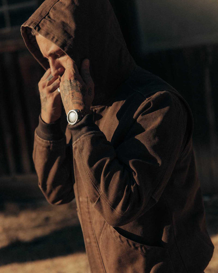 fit model adjusting the hood on The Workhorse Hoodie in Aged Penny Chipped Canvas