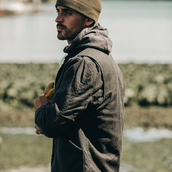 fit model wearing The Workhorse Jacket in Coal Boss Duck, looking left