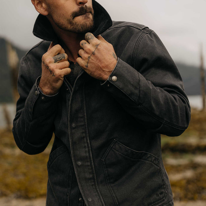fit model adjusting the collar on The Workhorse Jacket in Coal Chipped Canvas