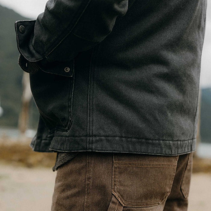 fit model showing off the bottom of The Workhorse Jacket in Coal Chipped Canvas