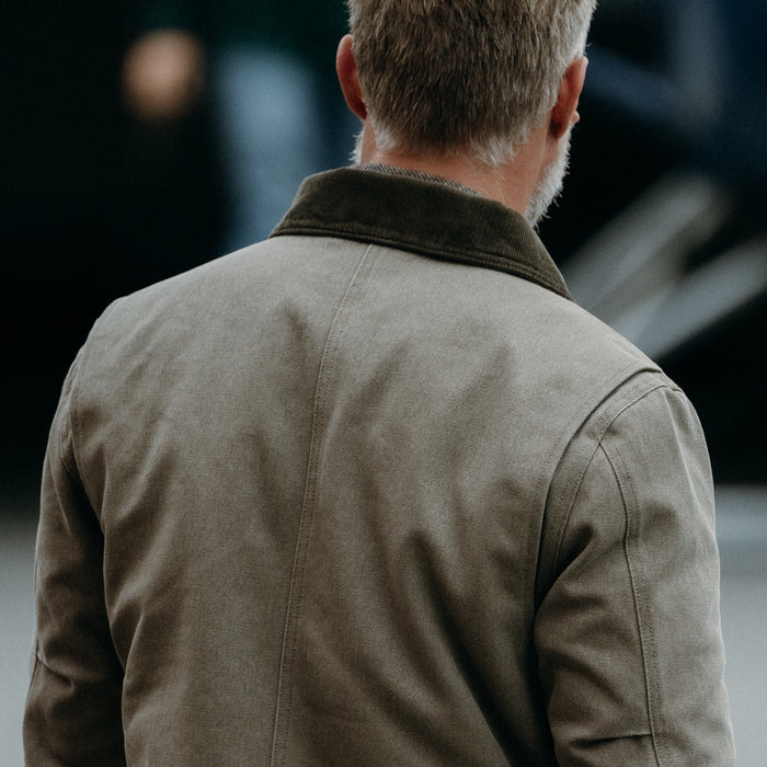 fit model showing off the back of The Workhorse Jacket in Stone Chipped Canvas